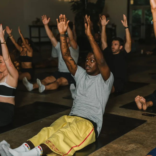 Pilates class reaching overhead at Yacht Club with Kinfolk Pilates