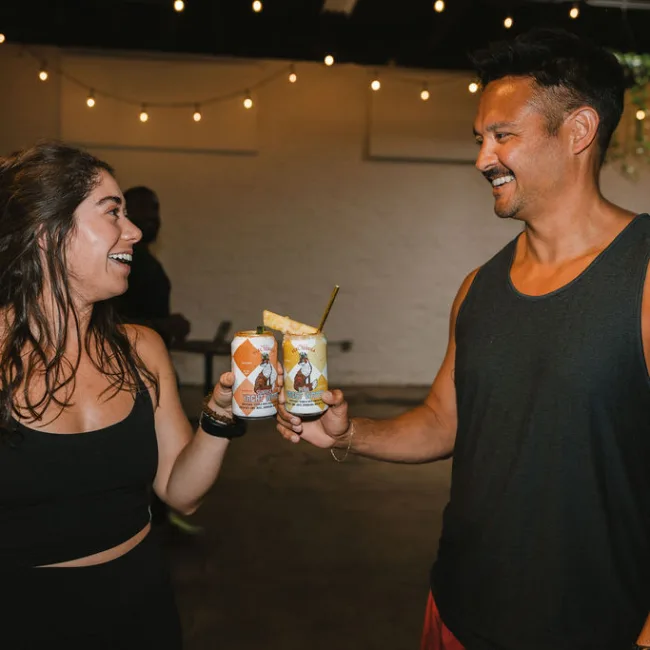 Guests toasting with Yacht Water cocktails at Yacht Club